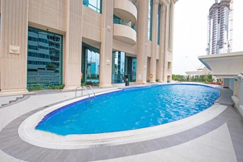 a large swimming pool in front of a building at Greatest location Dubai in Dubai