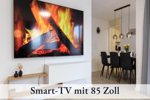 a living room with a tv with a fireplace at Relax-Apartment-One Ravensburg in Ravensburg