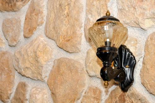 a street light attached to a stone wall at Forest View House Seta in Séta