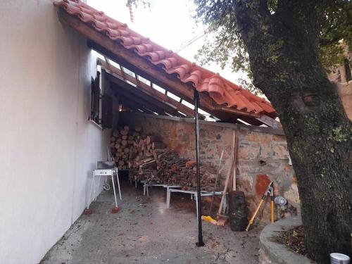 a building with awning with a pile of wood at Forest View House Seta in Séta