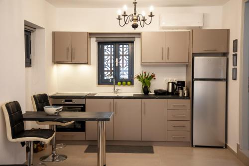 a kitchen with a table and a refrigerator at Simo's Apartments in Egina