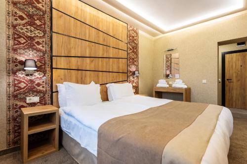 a bedroom with a large bed in a room at SPA Hotel Olymp in Velingrad