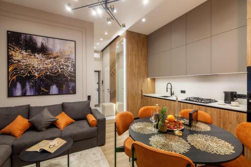uma sala de estar e cozinha com um sofá e uma mesa em Alfa Apartments Ivana Franka em Lviv