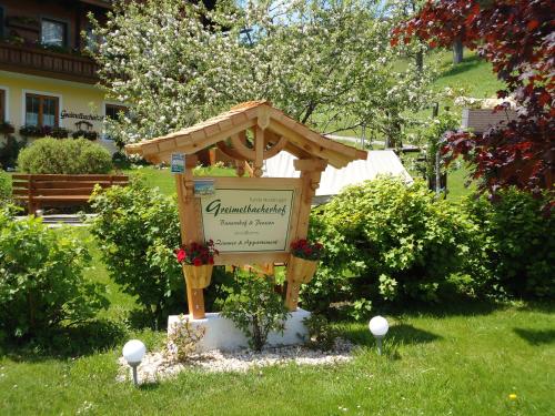 a sign in the middle of a yard with at Pension-Greimelbacherhof in Ramsau am Dachstein