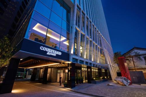 a building with a sign on the front of it at Courtyard by Marriott Seoul Namdaemun in Seoul