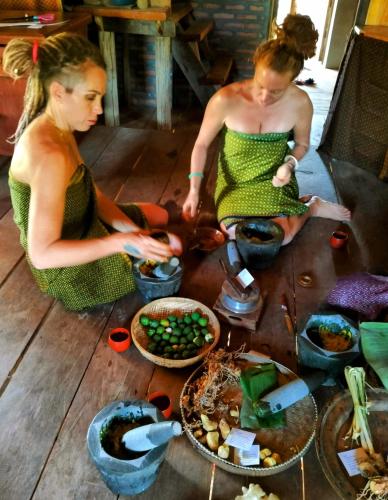 two women sitting on the floor with bowls of food at Banteay Srey Women's Only Traditional Spa and Homestay in Kampot