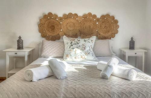 a bed with a wooden headboard and pillows on it at El Recuerdo in Córdoba