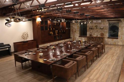 a large dining room with a long table and chairs at Korek Mountain Resort in Erbil