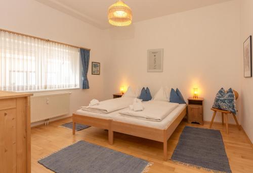 a bedroom with a bed with blue pillows on it at Appartements Maria Stewart by Schladming-Appartements in Schladming