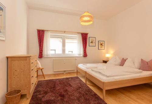 a living room with a bed and a window at Appartements Maria Stewart by Schladming-Appartements in Schladming