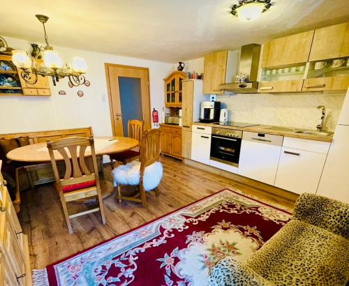a kitchen with a table and a dining room at Ferienwohnung Alpensymphonie mit 110 m2 und sonnigem Balkon in Burgberg
