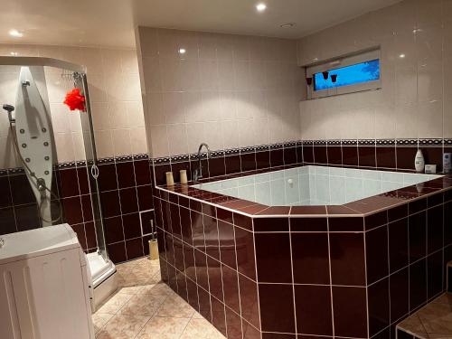a large bathroom with a tub and a shower at Luxurious En-suit room with Sauna in Pyussi