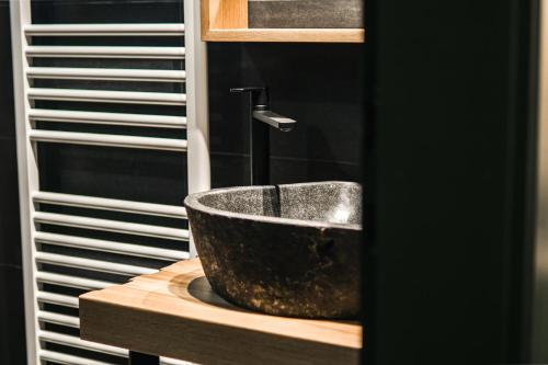 a bathroom with a stone sink on a counter at Bauernhaus 128 - Boutiquestube 1 Oberkirchleitn by S4Y in Sankt Oswald