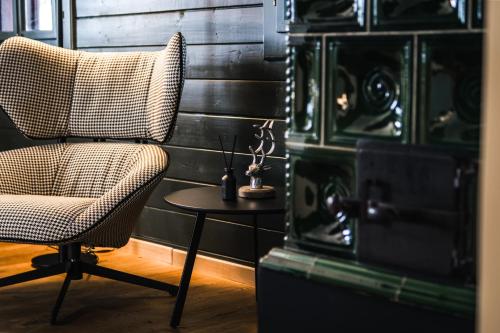 a chair and a table in a room at Bauernhaus 128 - Boutiquestube 1 Oberkirchleitn by S4Y in Sankt Oswald