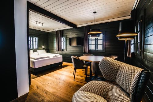 a bedroom with a bed and a table and chairs at Bauernhaus 128 - Boutiquestube 1 Oberkirchleitn by S4Y in Sankt Oswald