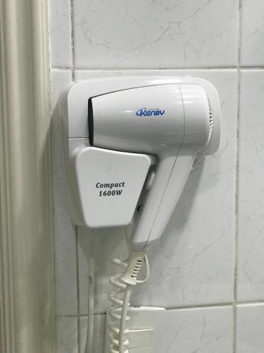 a phone in a bathroom with a corded hookup at Riviera de São Lourenço Amarilis 302 in Bertioga