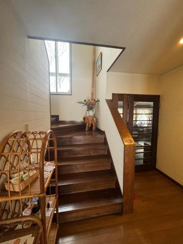a staircase in a room with a stair case at ALBERGO DEL PESCATORE in Minamiaizu