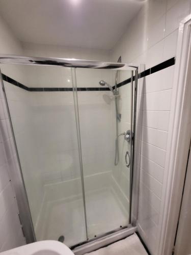 a shower stall in a bathroom with a toilet at 2 Bedroom Flat - both rooms are ensuite in Elswick