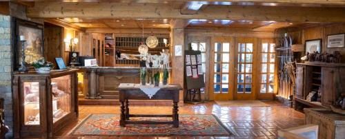 a room with a table in a room with wooden walls at Gran Baita Hotel & Wellness in Courmayeur