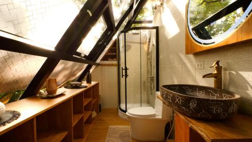 a bathroom with a sink and a glass shower at Unique Stays at Karuna El Nido - The Pyramid in El Nido