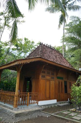 a small house in the middle of a forest at Villa Embun Batukaras in Batukaras
