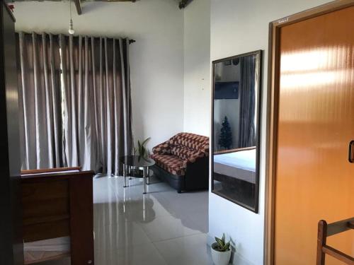 a bedroom with a bed and a couch in a room at Sky home stay in Kandy