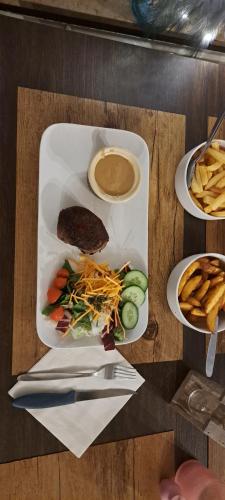 a plate of food on a wooden table with food at Dikke Vriend , herberg & taverne in Chiny