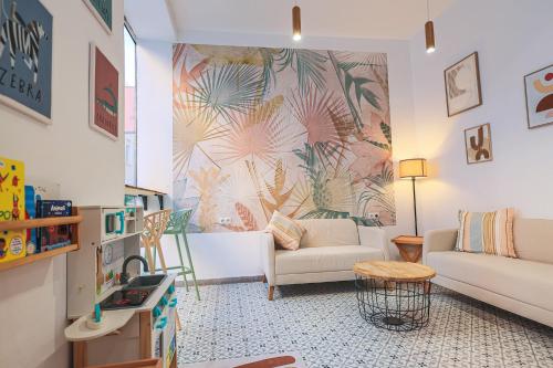 a living room with a couch and a table at The Clover in Seville
