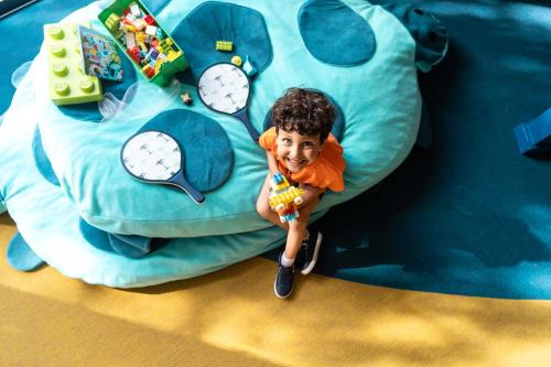 a young boy is sitting on a bouncy castle at Pullman Mazagan Royal Golf & Spa in El Jadida
