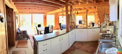 a kitchen with white cabinets and a counter top at VISTA MAR casa familiar para 8 personas in Pichilemu