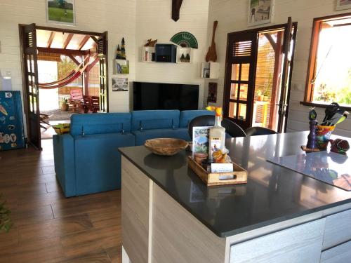 a kitchen with a blue couch and a counter top at Les Frangipaniers de la Pelée in Saint-Pierre