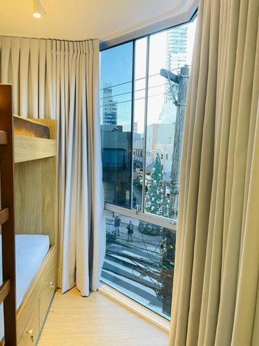 a room with a large window with a view of a city at Conforto e a melhor localização in Balneário Camboriú