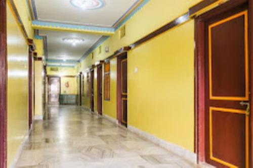 an empty hallway in a building with yellow walls at Indra Bhawan Lodge, Cuttack in Cuttack