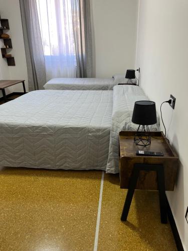 a bedroom with a bed and a table with a lamp at Gaslini Sea House in Genova