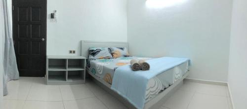 a bedroom with a bed with a picture of a person at Modern 3 bedrooms House, Walking distance to Kulim Town by Mr Homestay in Kulim