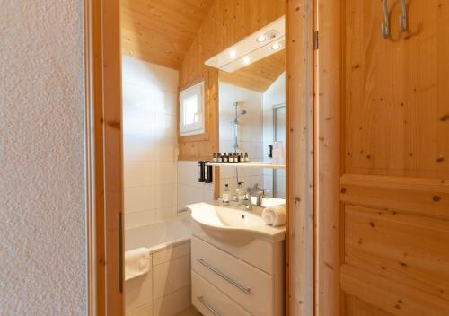 a bathroom with a sink and a bath tub at 1A Chalet Nest - Grillen und Wandern, Panorama Sauna! in Klippitztorl