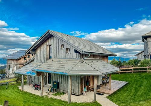 a large wooden barn with a blue roof at 1A Chalet Nest - Grillen, Wandern, Panorama Sauna! in Klippitztorl