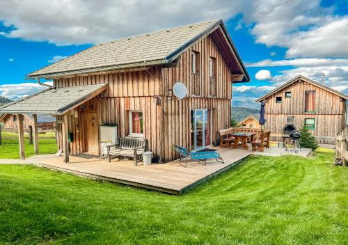 a barn with a deck and a patio at 1A Chalet Nest - Grillen, Wandern, Panorama Sauna! in Klippitztorl