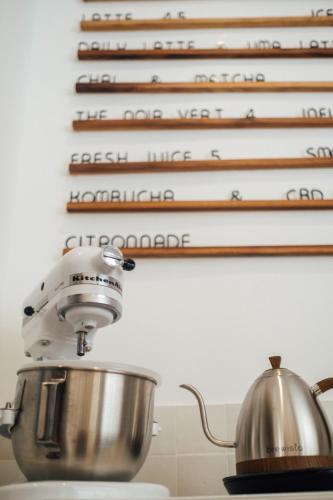 - un mixeur de cuisine installé sur un comptoir avec un mur de livres de cuisine dans l'établissement - Maison ÛMA - Wifi, Netflix, Mer et Centre, à Marseille