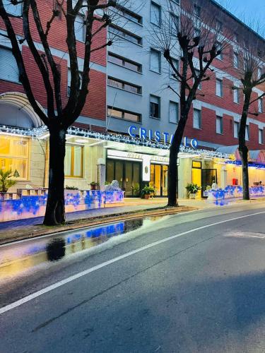 an empty street in front of a building with christmas lights at Hotel Cristallo - Chianciano Terme in Chianciano Terme