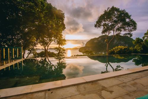 a pool with a view of a body of water at The Seaview Dome - Glamping at Karuna El Nido in El Nido
