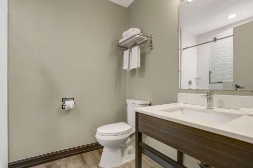 La salle de bains est pourvue de toilettes blanches et d'un lavabo. dans l'établissement Motel 6 San Diego, CA Airport Harbor, à San Diego