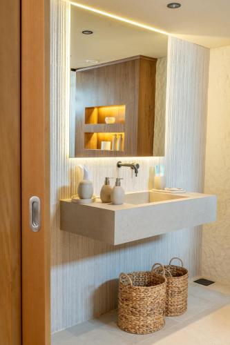 a bathroom with a sink and a mirror at Pura Eco Retreat, Jebel Hafit Desert Park in Al Ain