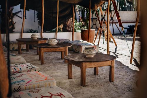 a room with tables and bowls on top of it at La Maison des Vagues in Sidi Kaouki