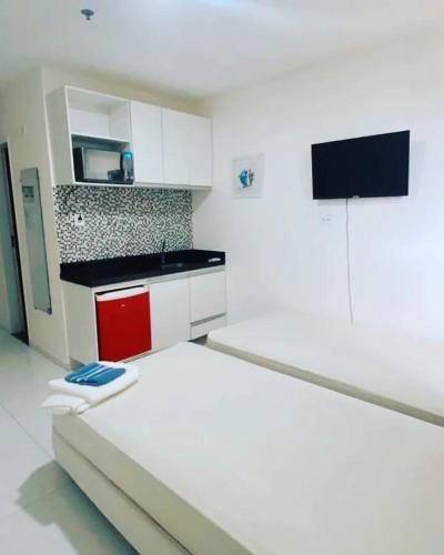 a white kitchen with a bed in a room at PRIME HOSPEDAGENS - RESIDÊNCIAL BELLÁGIO in São Luís