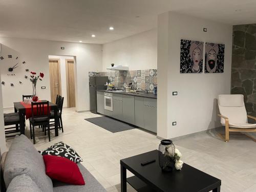 a living room with a couch and a table and a kitchen at La Palma del Nonno in Mazara del Vallo