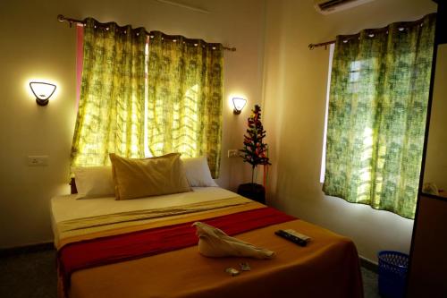 a bedroom with a bed with a christmas tree on it at Marari Anns Casa Beach Homestay in Mararikulam