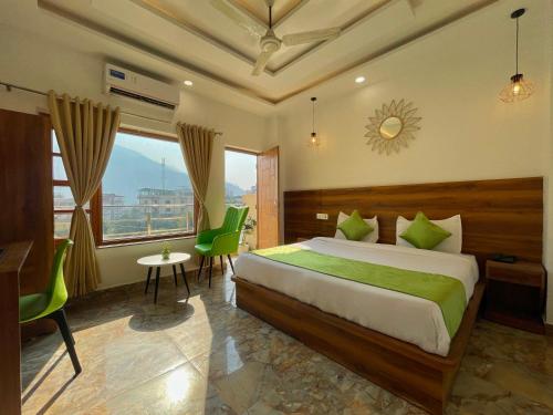 a bedroom with a bed and a table and chairs at Wanna Stay Rishikesh in Rishīkesh