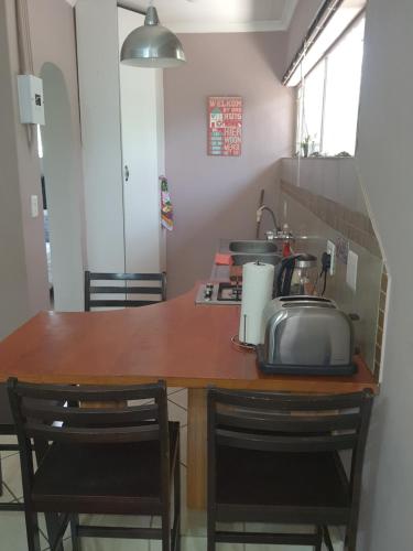 a kitchen with a counter with a sink and a microwave at Jean Michael Self-catering apartment for stay overs in Pretoria