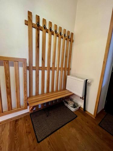 a room with a wooden bench and a radiator at U nás ve lhotě - apartmány / celá chalupa in Borotín